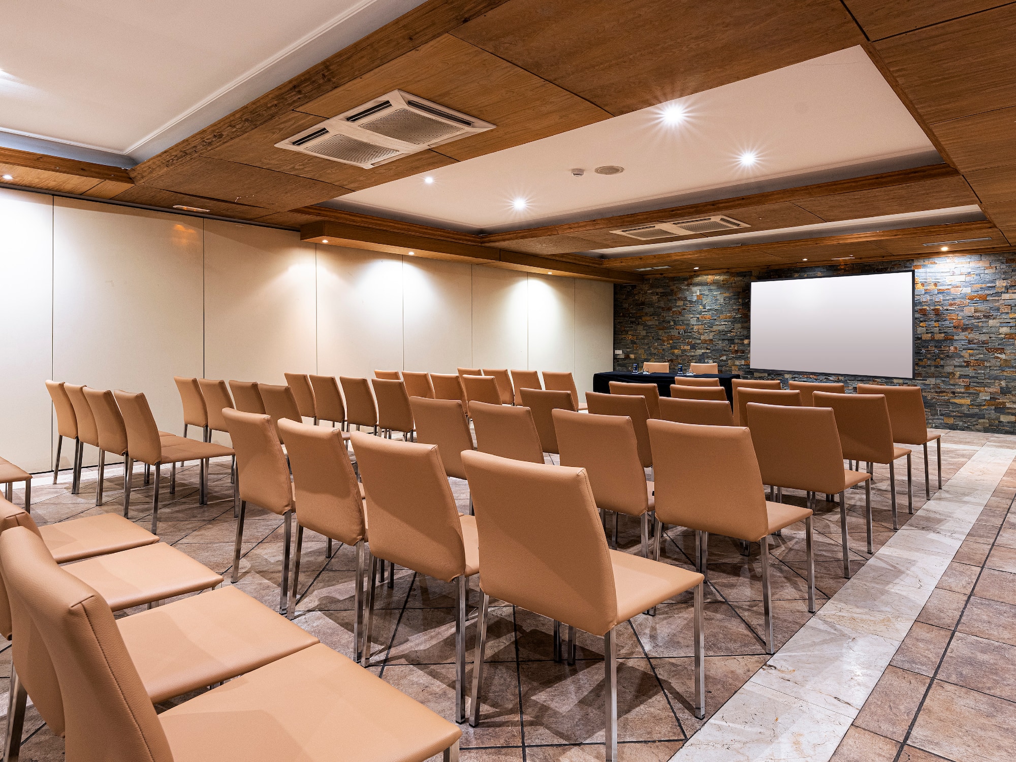 a room with chairs and a projector screen