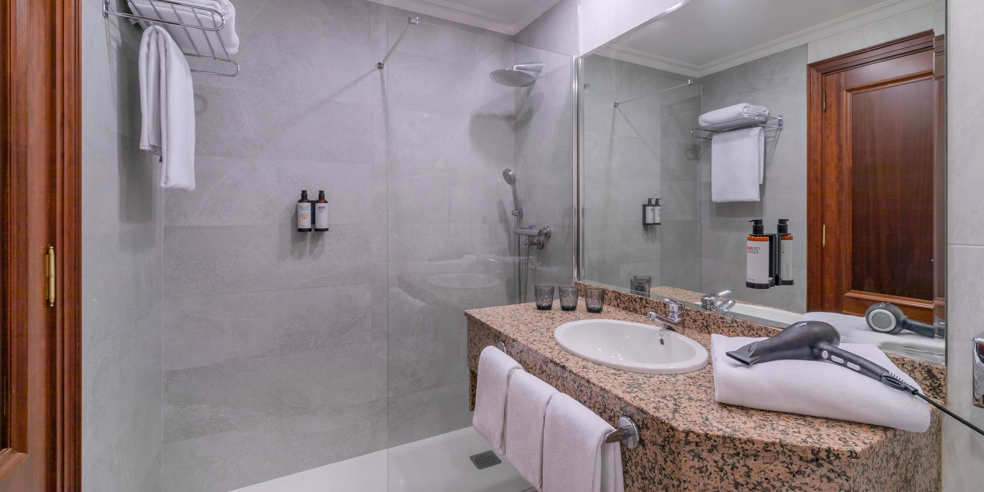 a bathroom with a shower and sink