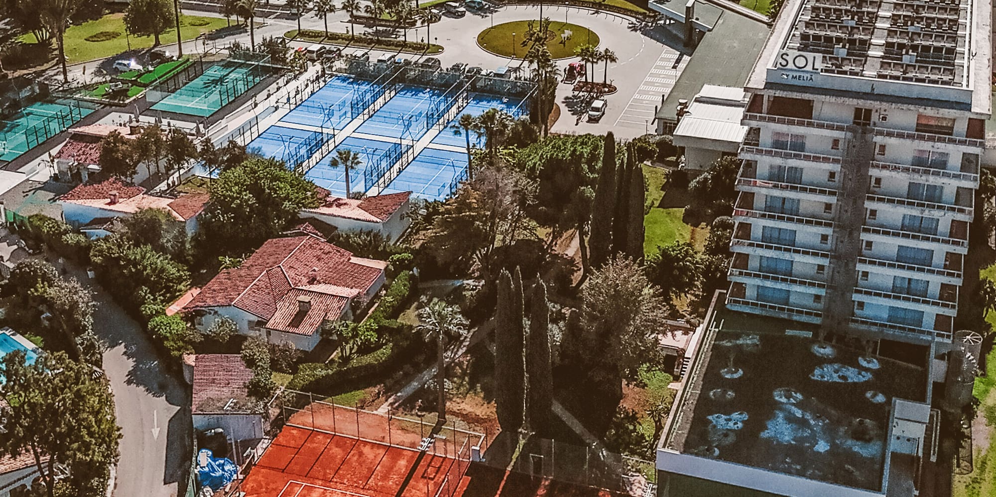 a tennis court next to a body of water