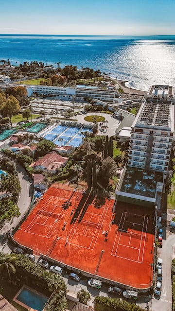 a tennis court next to a body of water