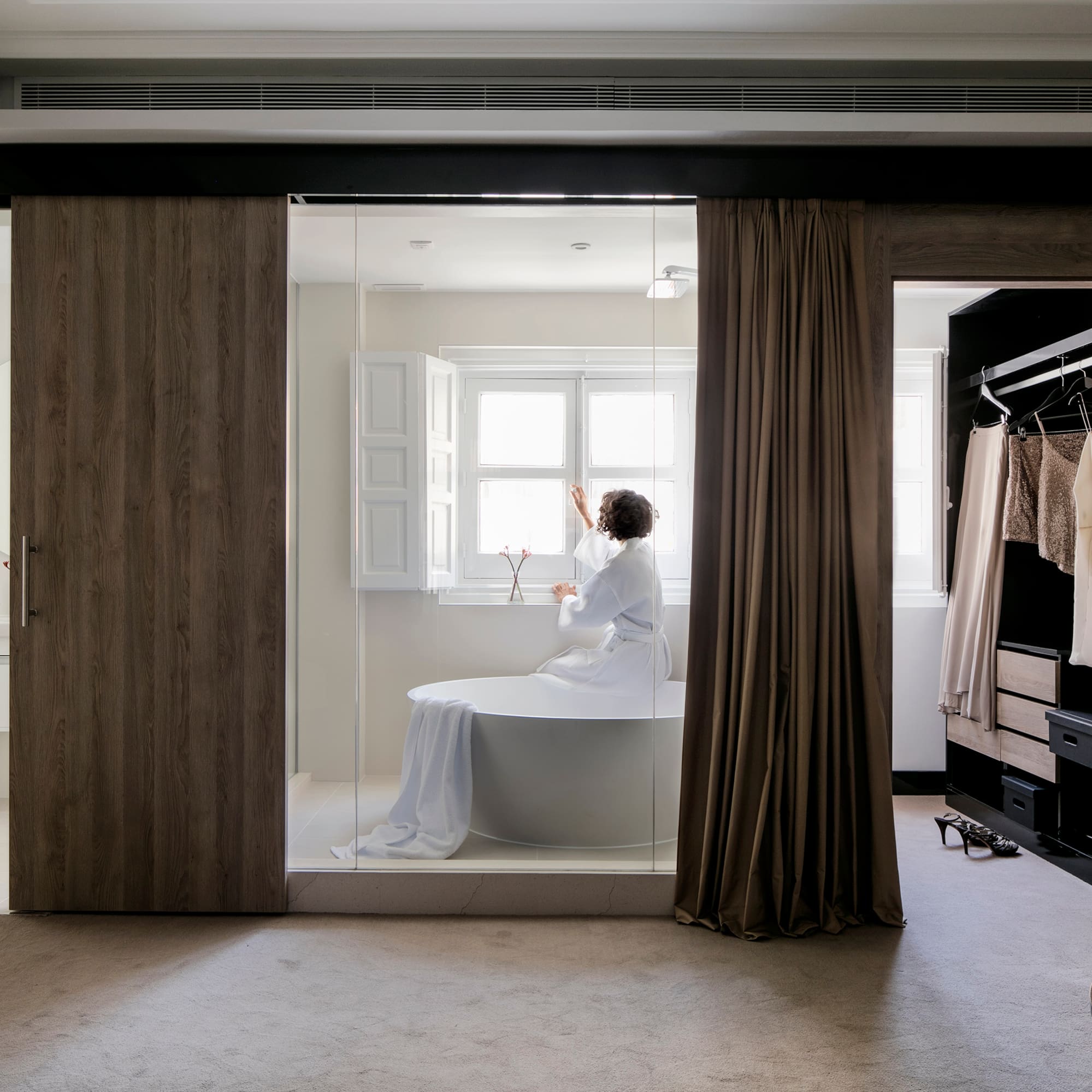 a woman in a white robe in a bathroom