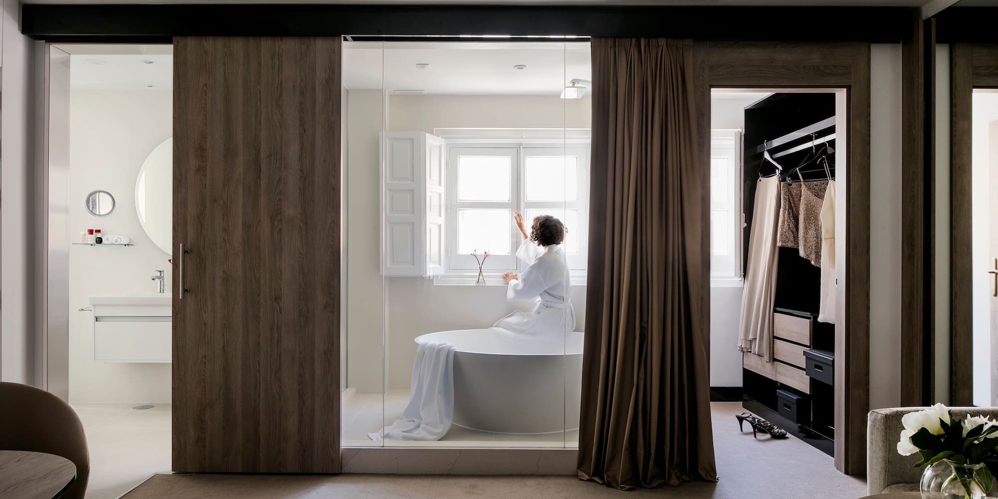 a woman in a white robe in a bathroom