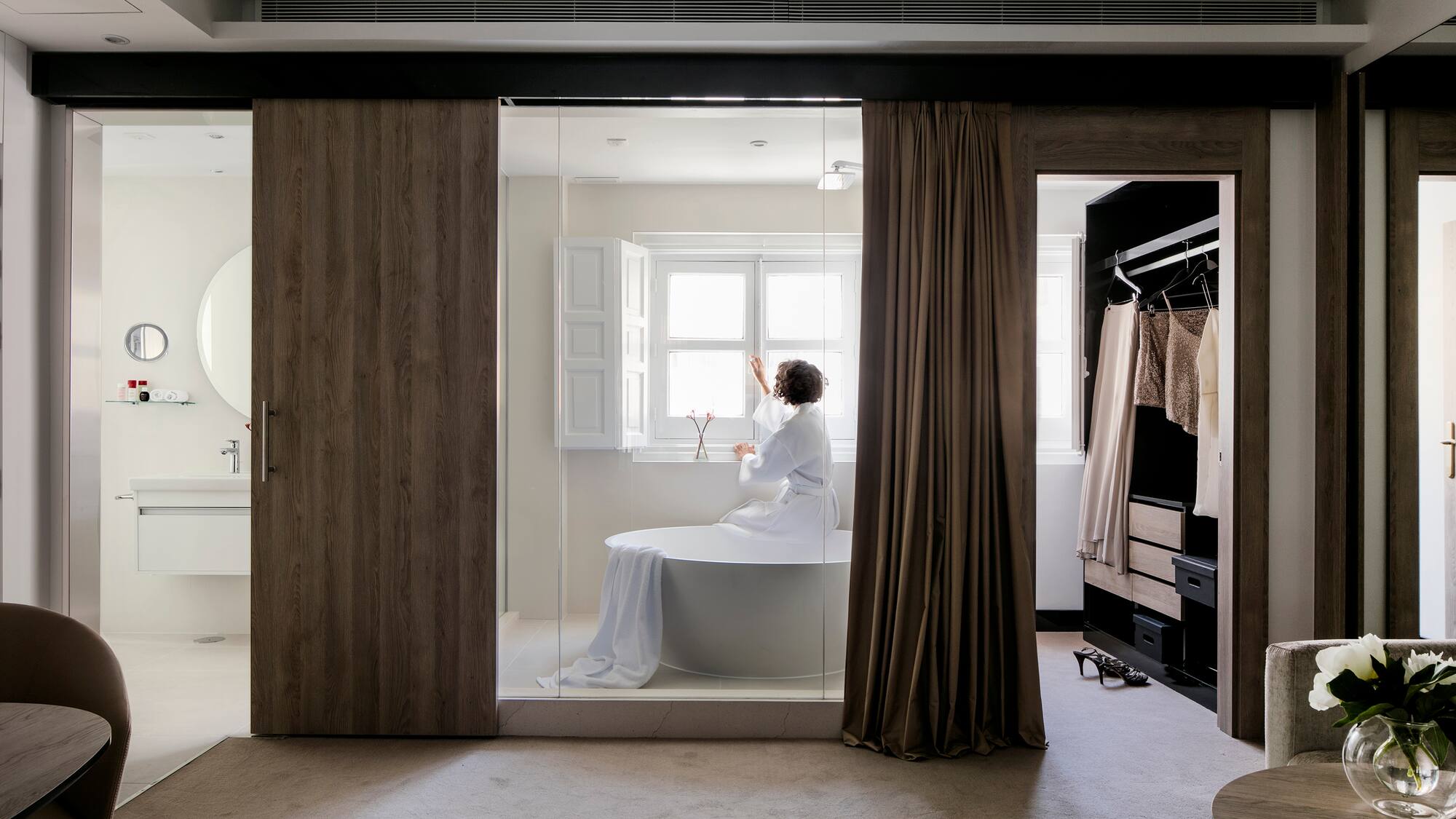 a woman in a white robe in a bathroom