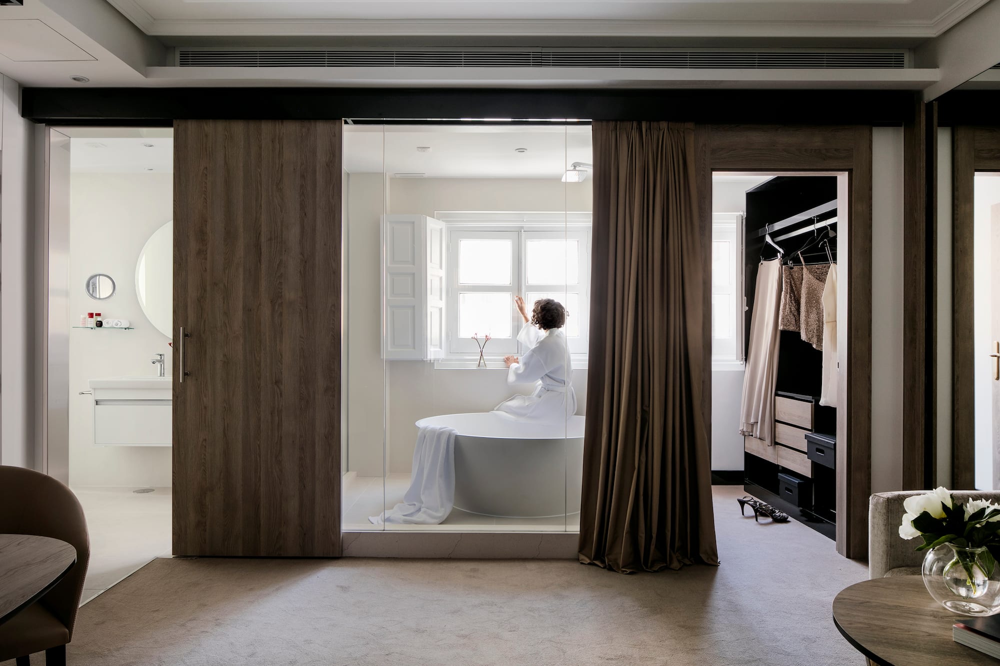 a woman in a white robe in a bathroom