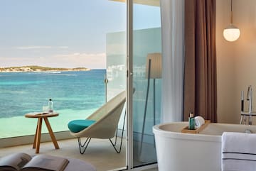 a room with a bathtub and a chair