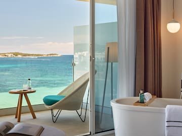 a room with a bathtub and a chair