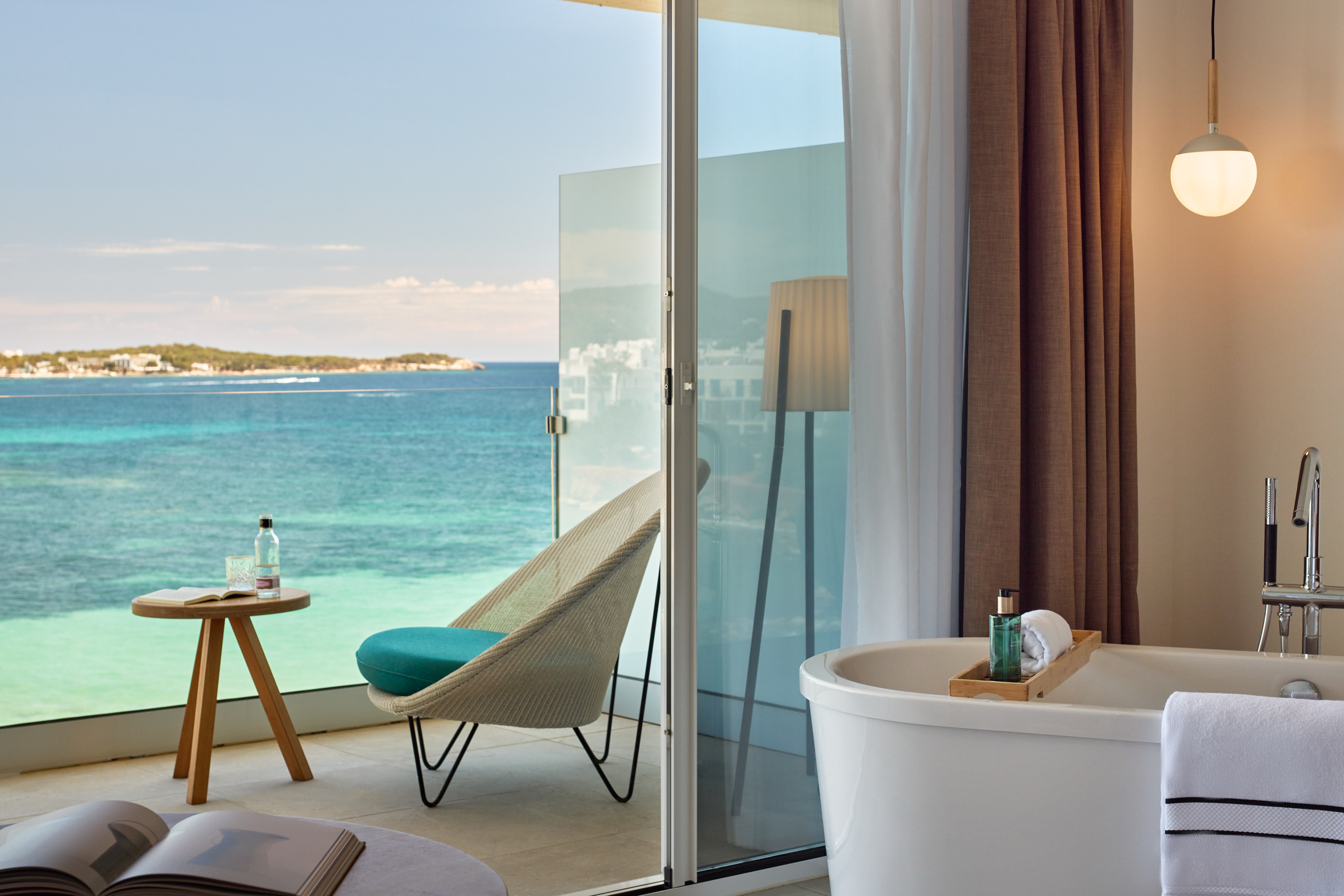 a room with a bathtub and a chair