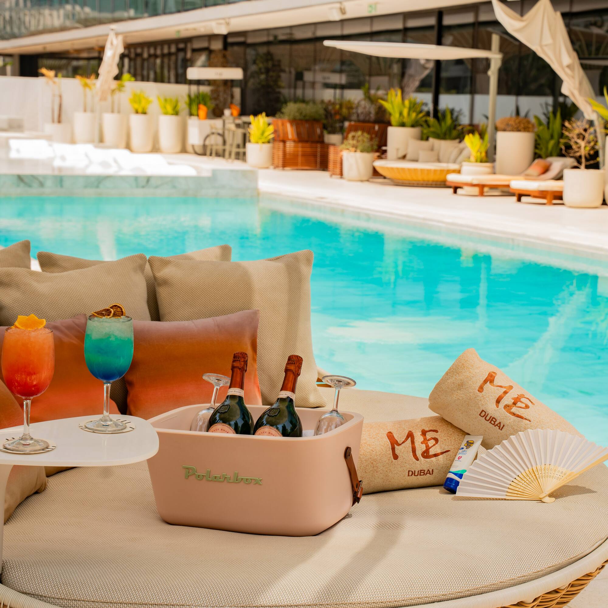 a pool with drinks and a cooler