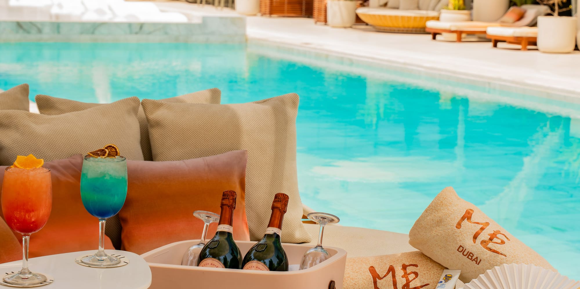 a pool with drinks and a cooler