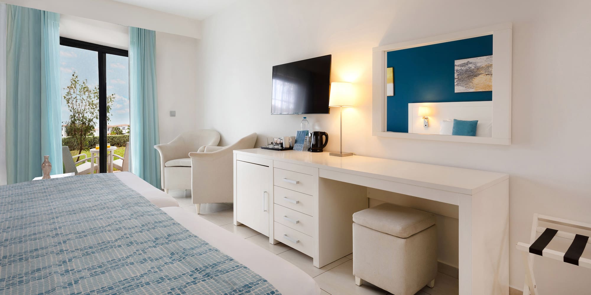 a room with a bed and a television