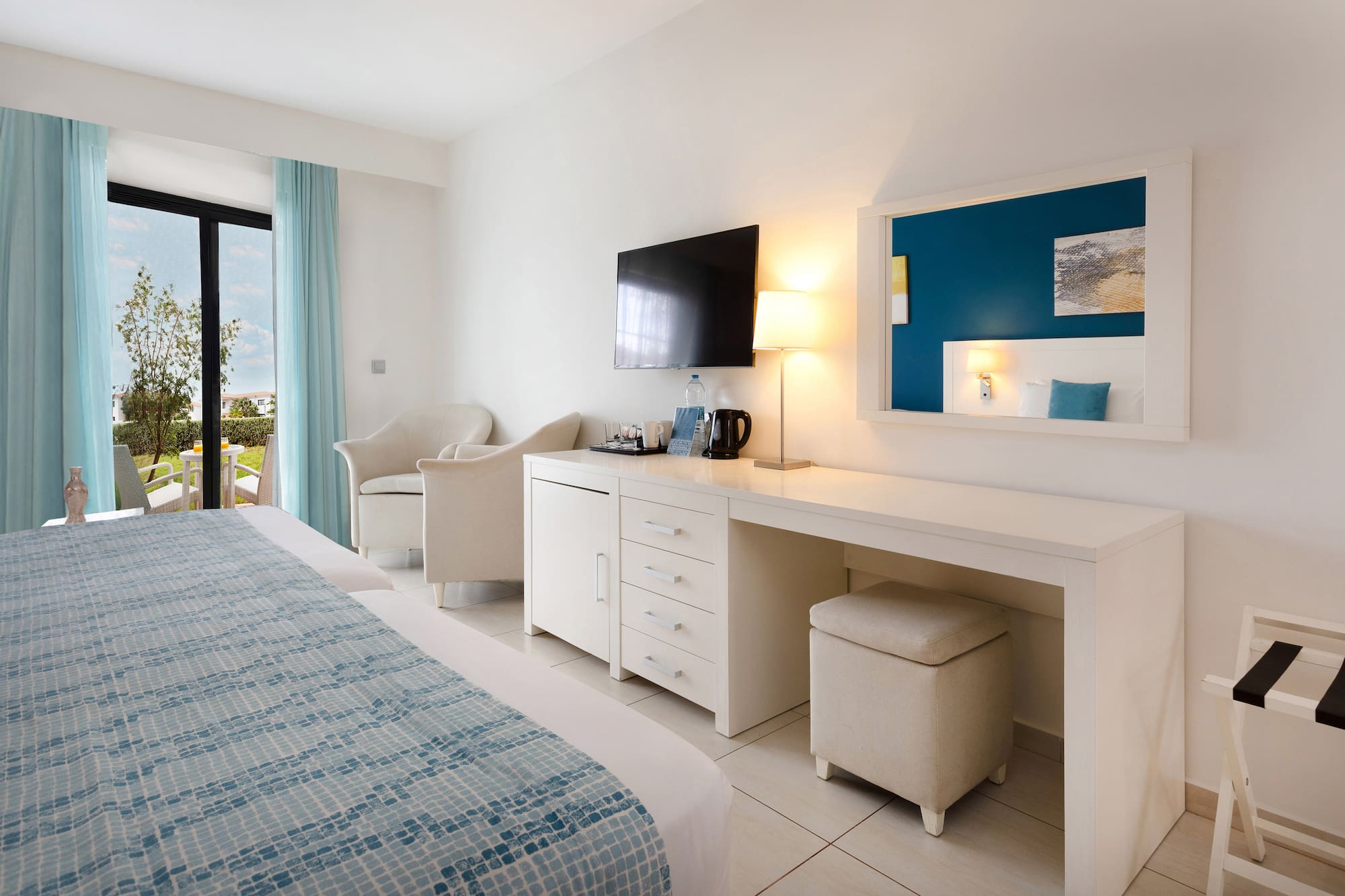 a room with a bed and a television