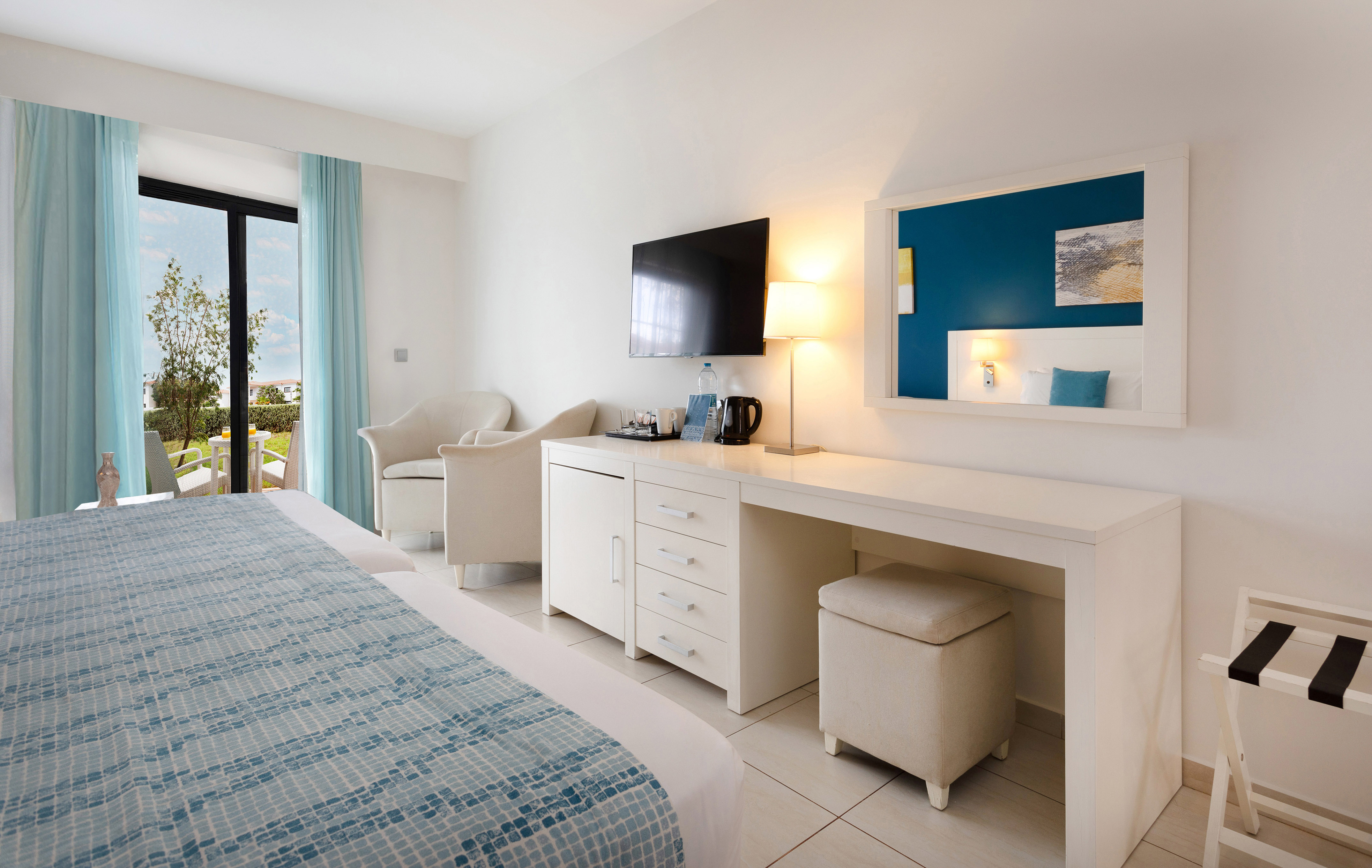 a room with a bed and a television