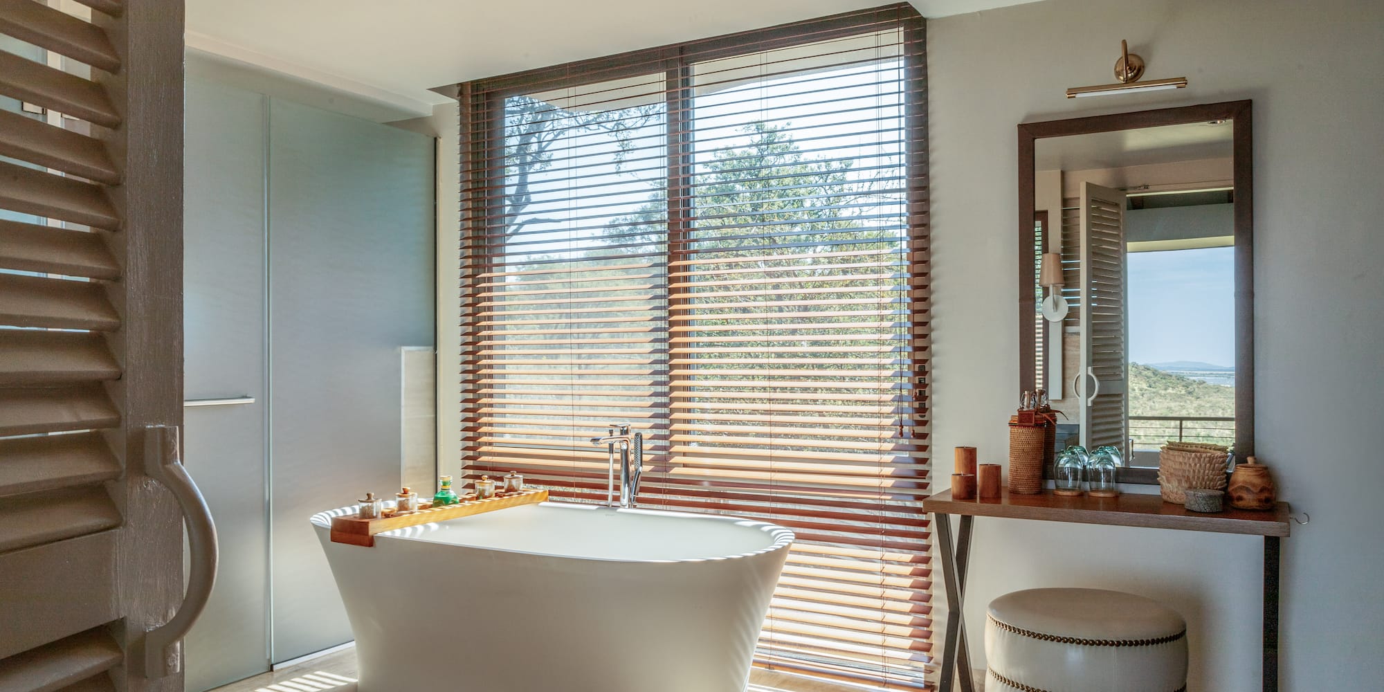 a bathroom with a tub and a mirror
