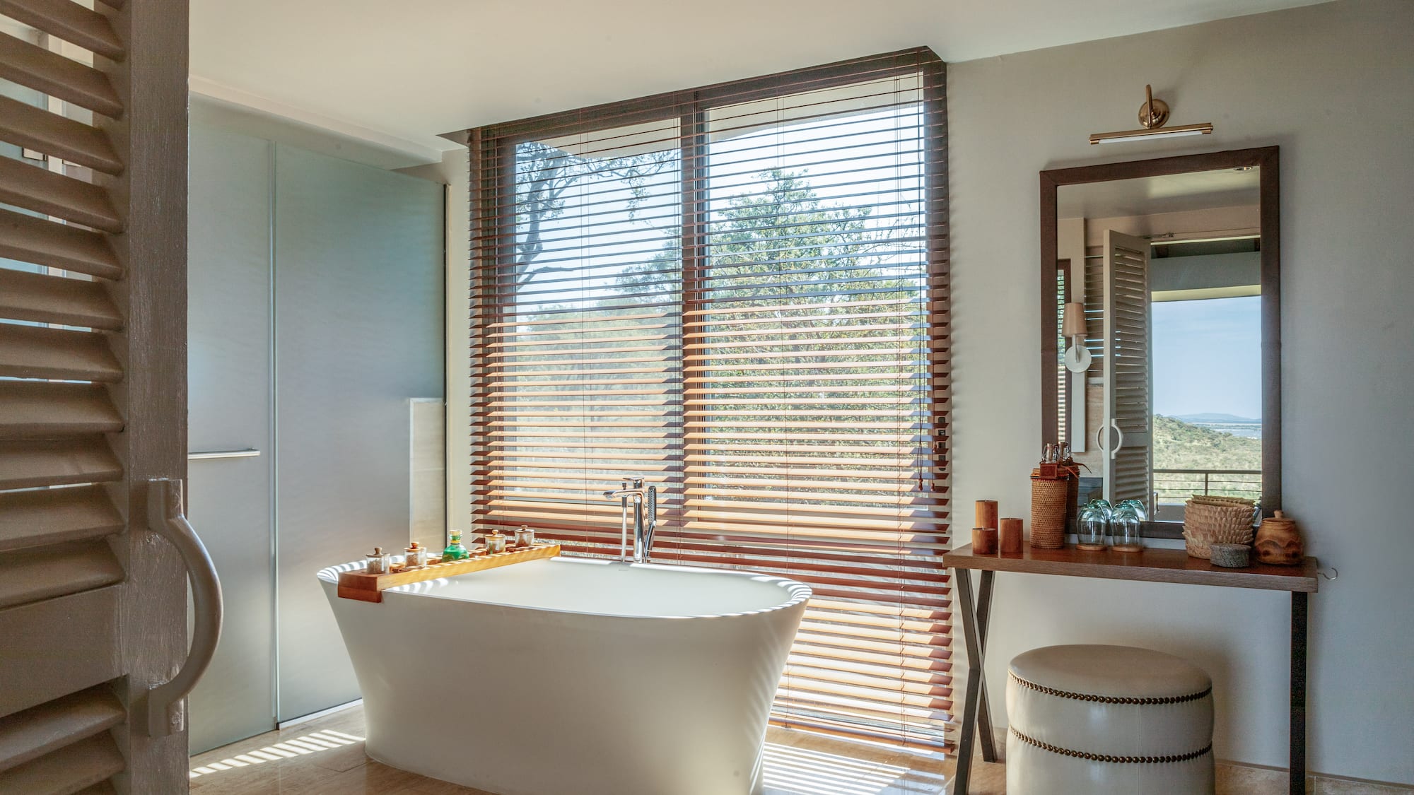 a bathroom with a tub and a mirror