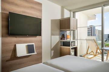 a room with a tv and a bed