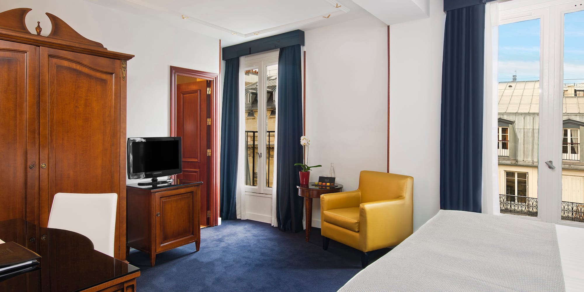 a room with a bed and a tv