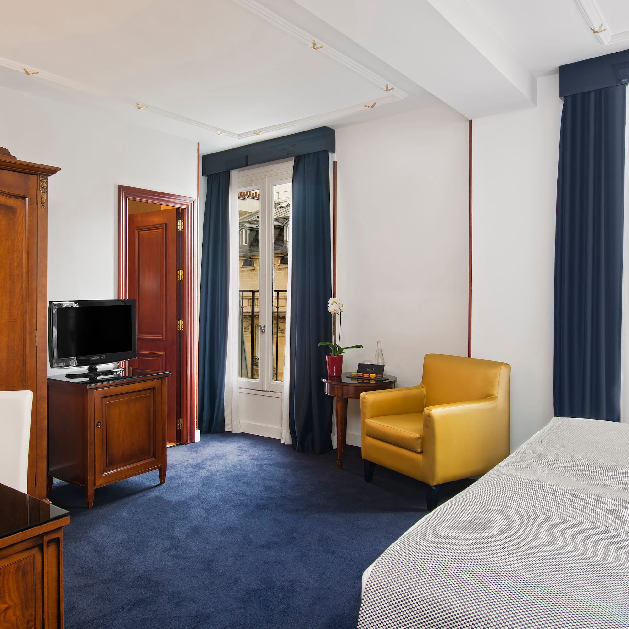 a room with a bed and a tv