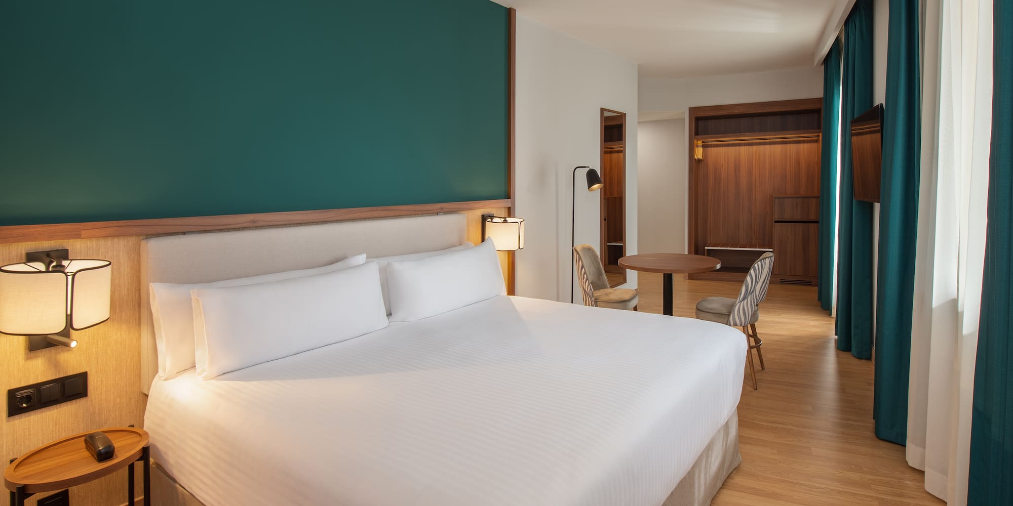 a hotel room with a bed and a table