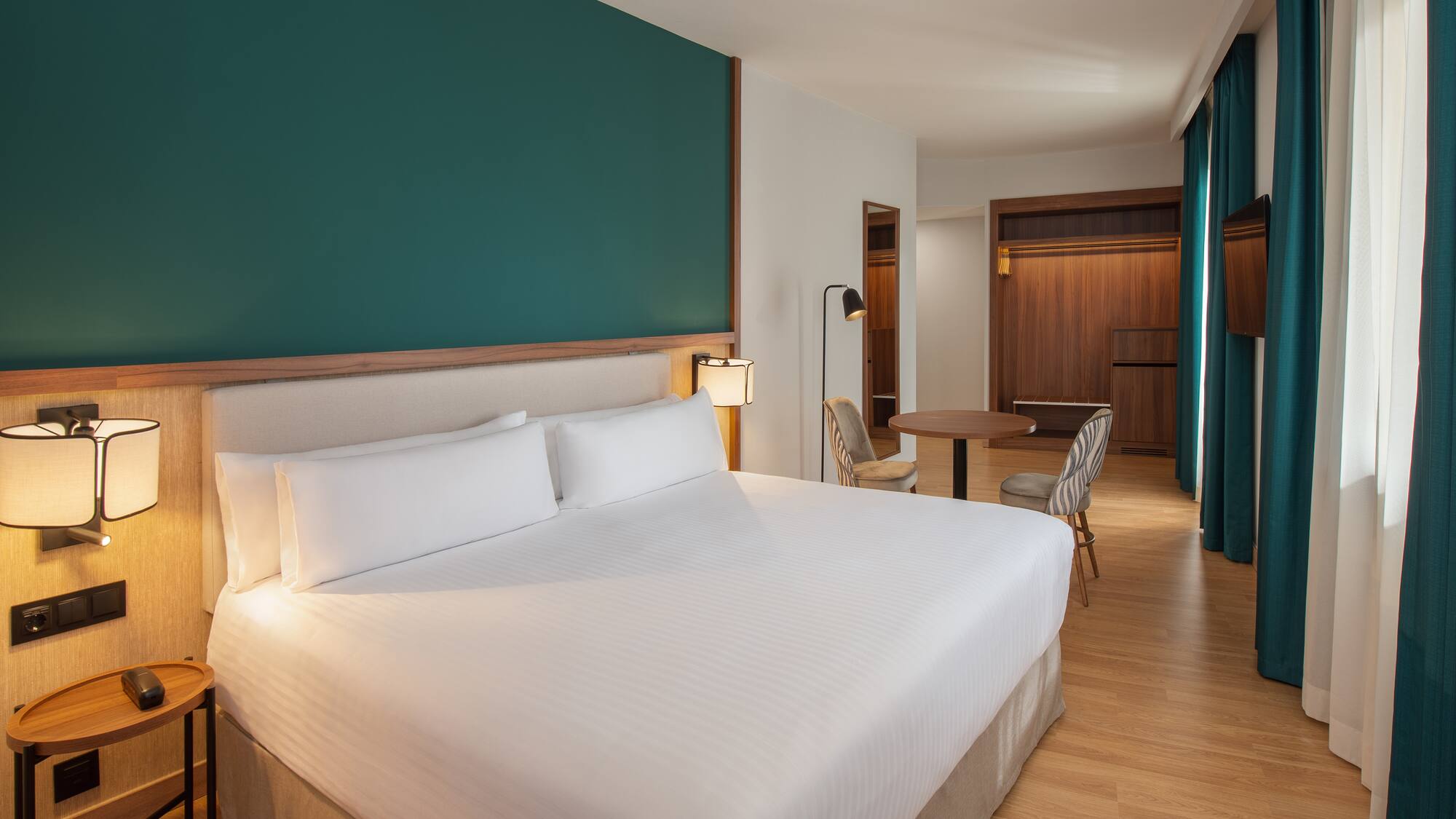 a hotel room with a bed and a table