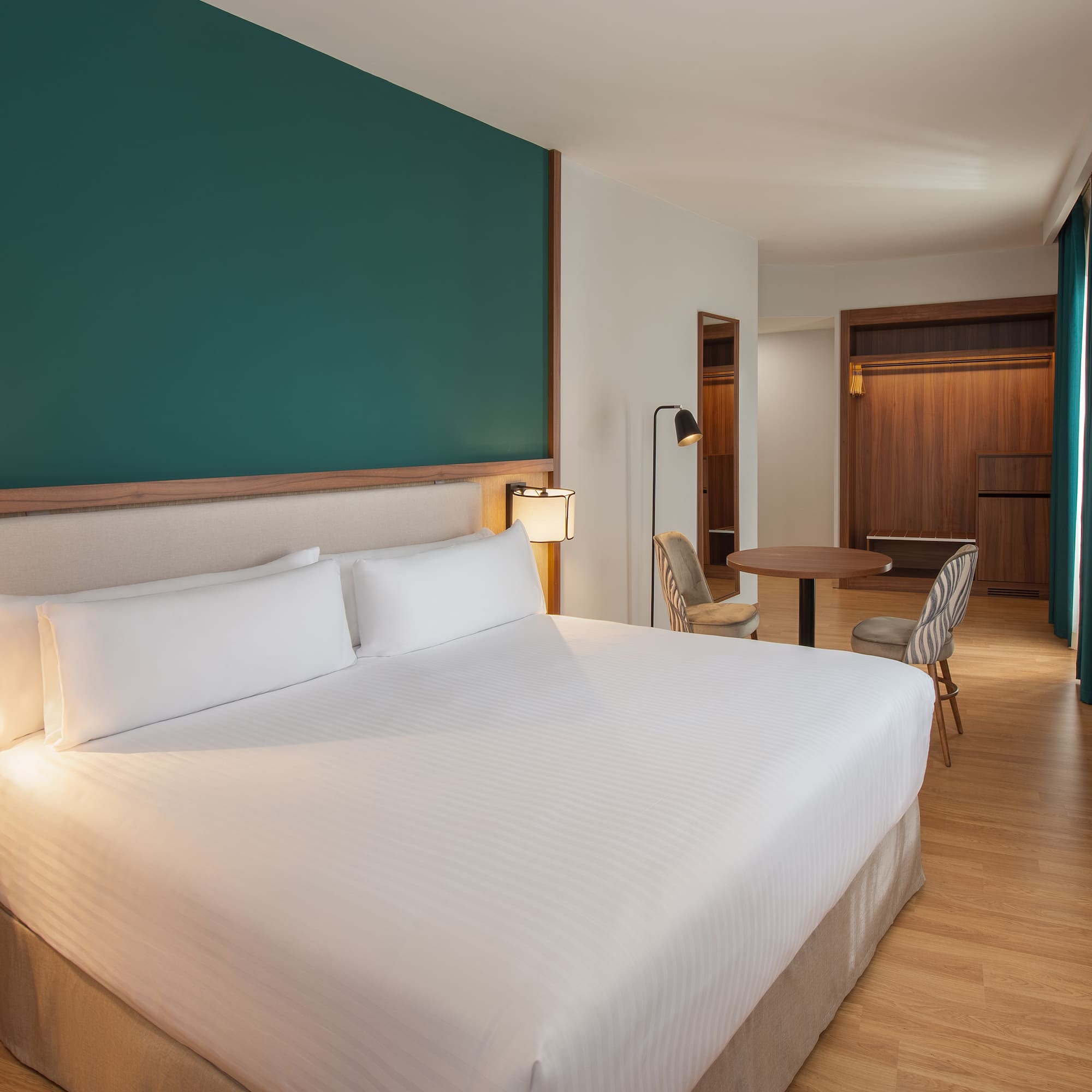 a hotel room with a bed and a table