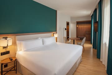 a hotel room with a bed and a table