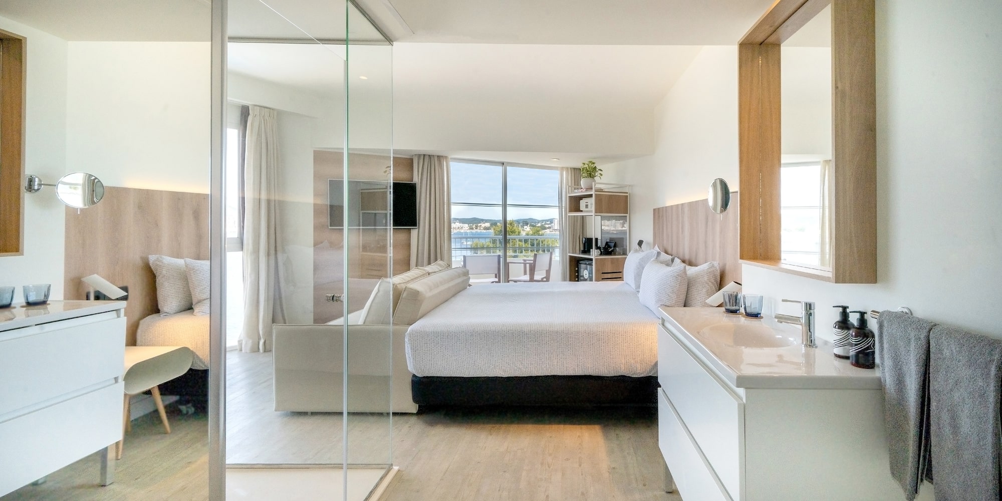 a bedroom with a glass door and a bed