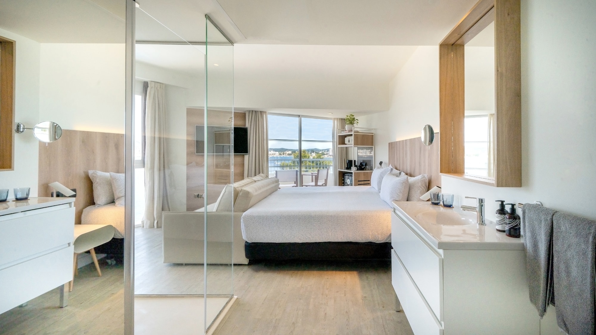 a bedroom with a glass door and a bed