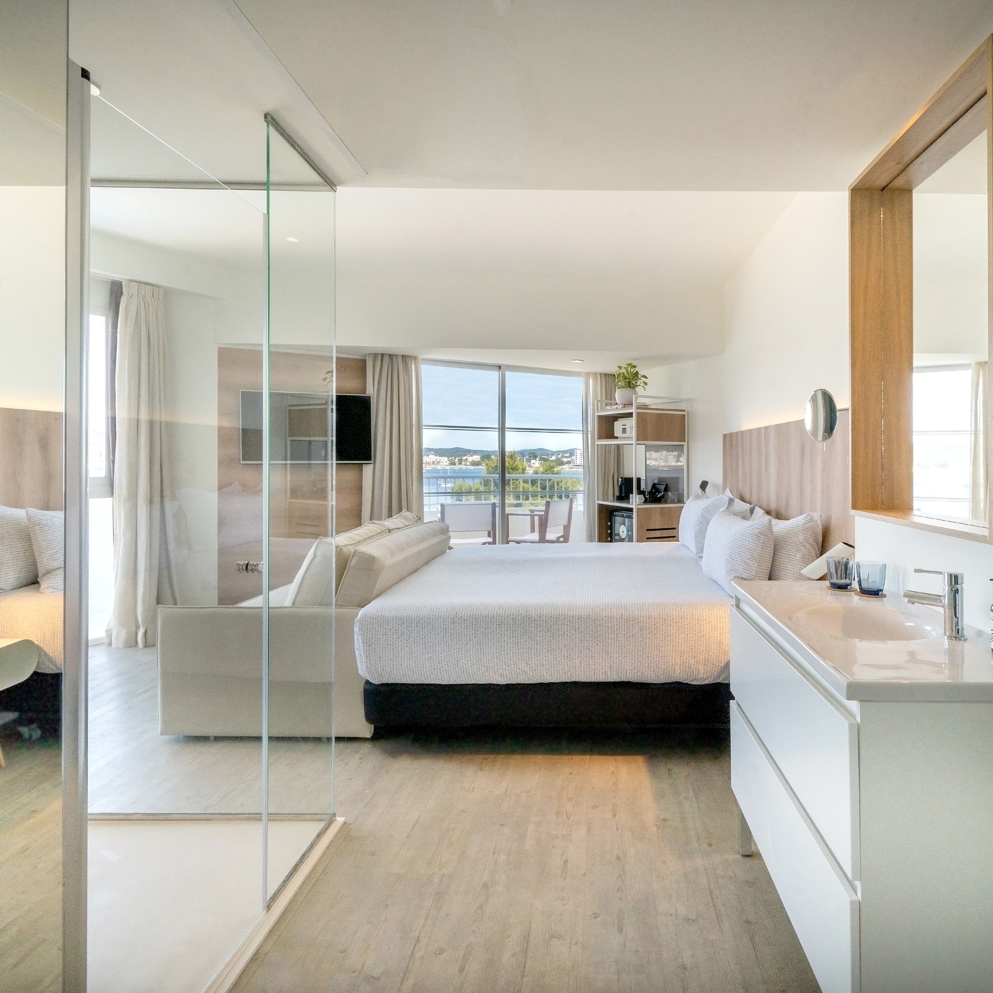 a bedroom with a glass door and a bed