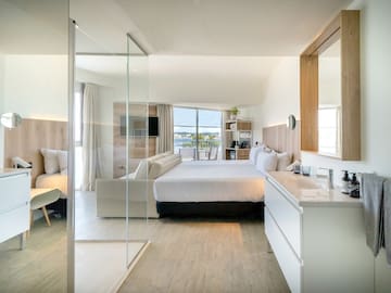 a bedroom with a glass door and a bed