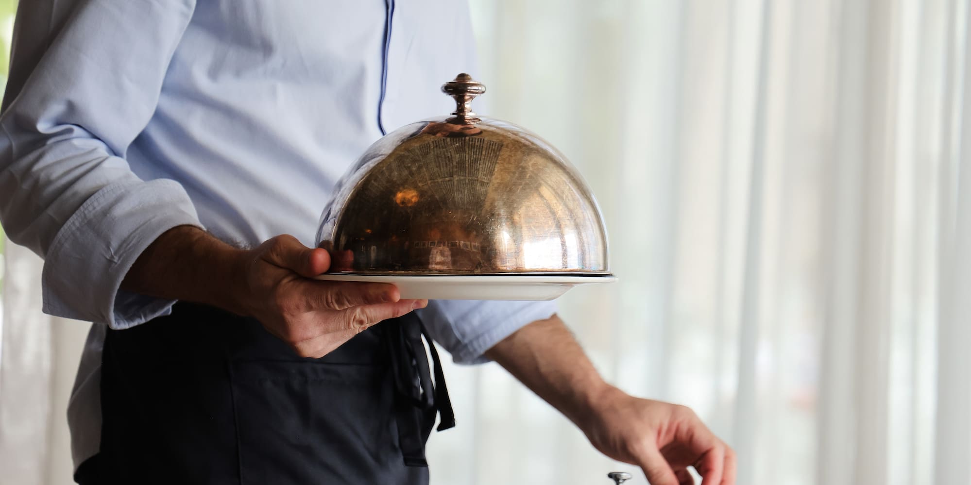 a man holding a tray with a lid