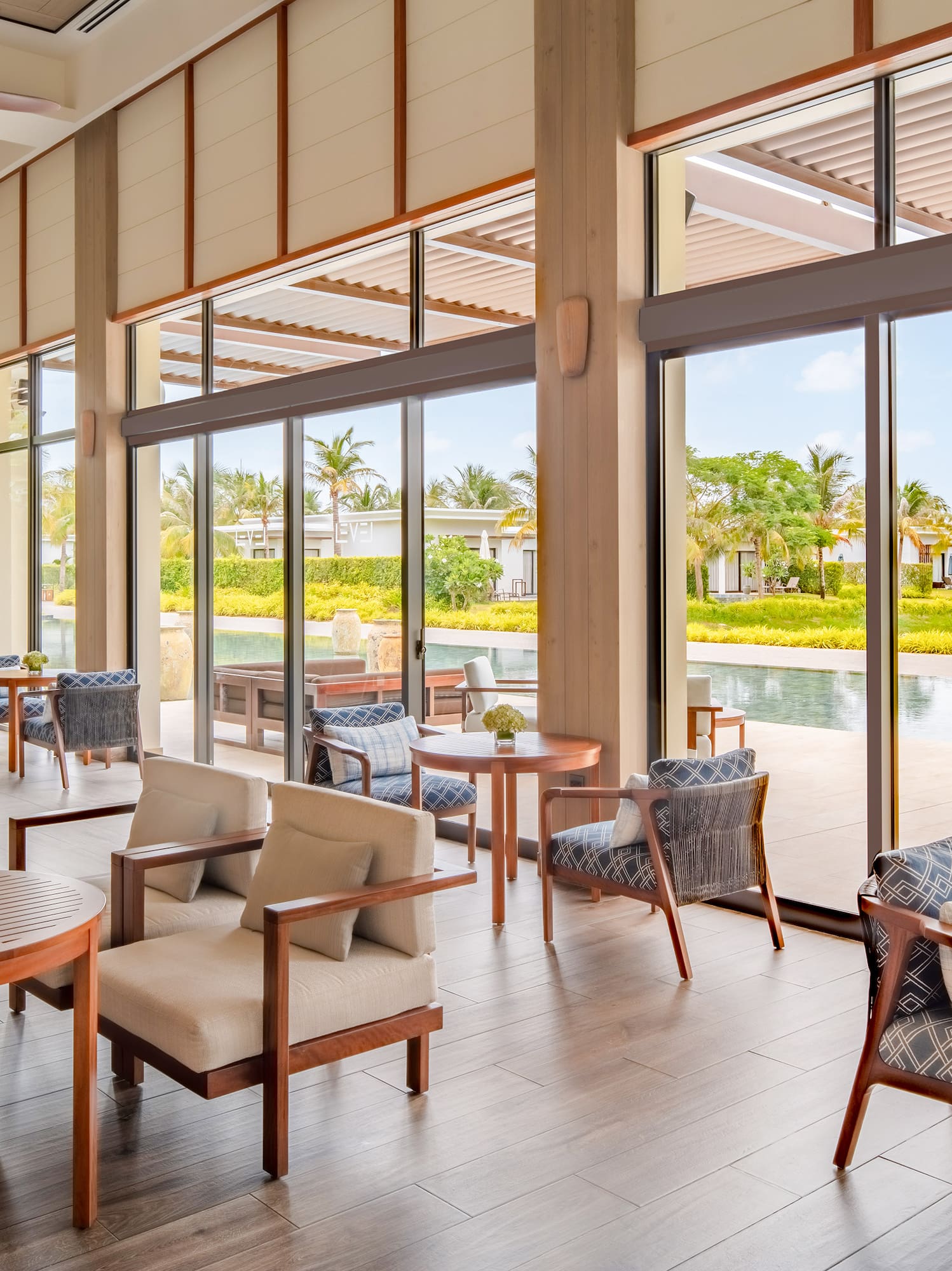 a room with chairs and tables and a pool