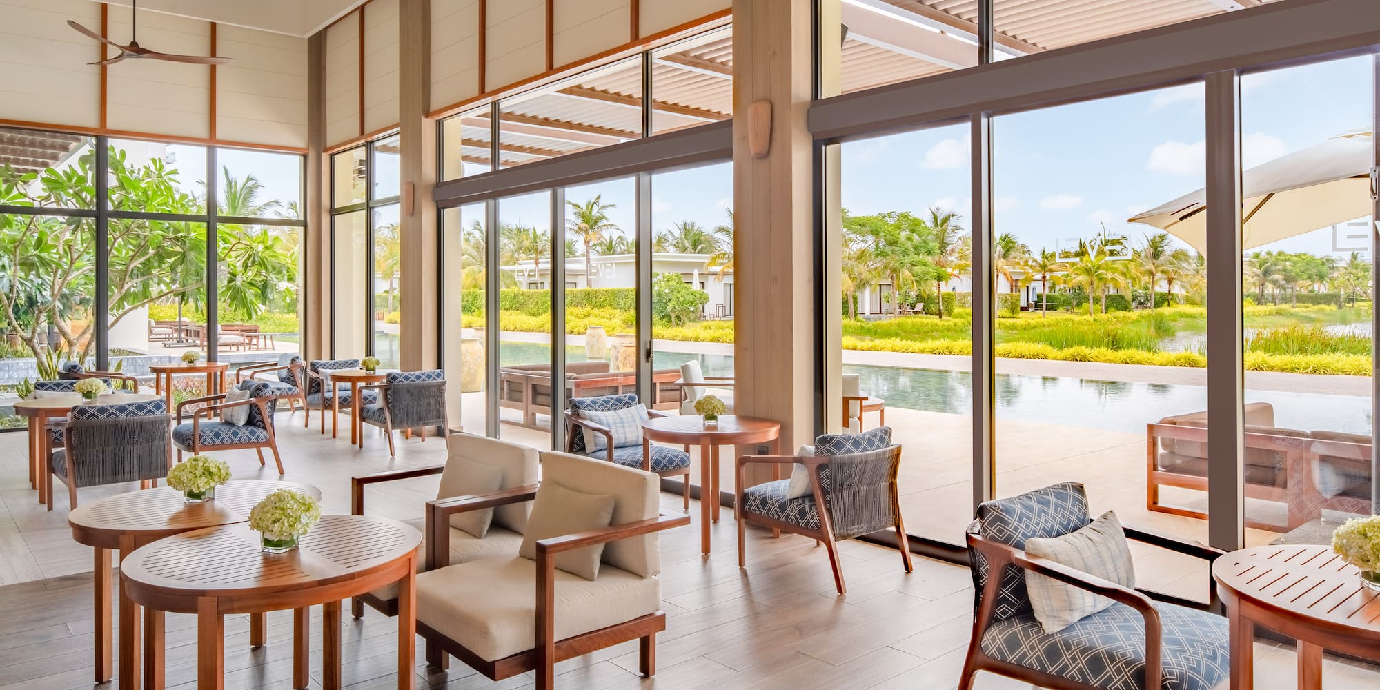 a room with chairs and tables and a pool