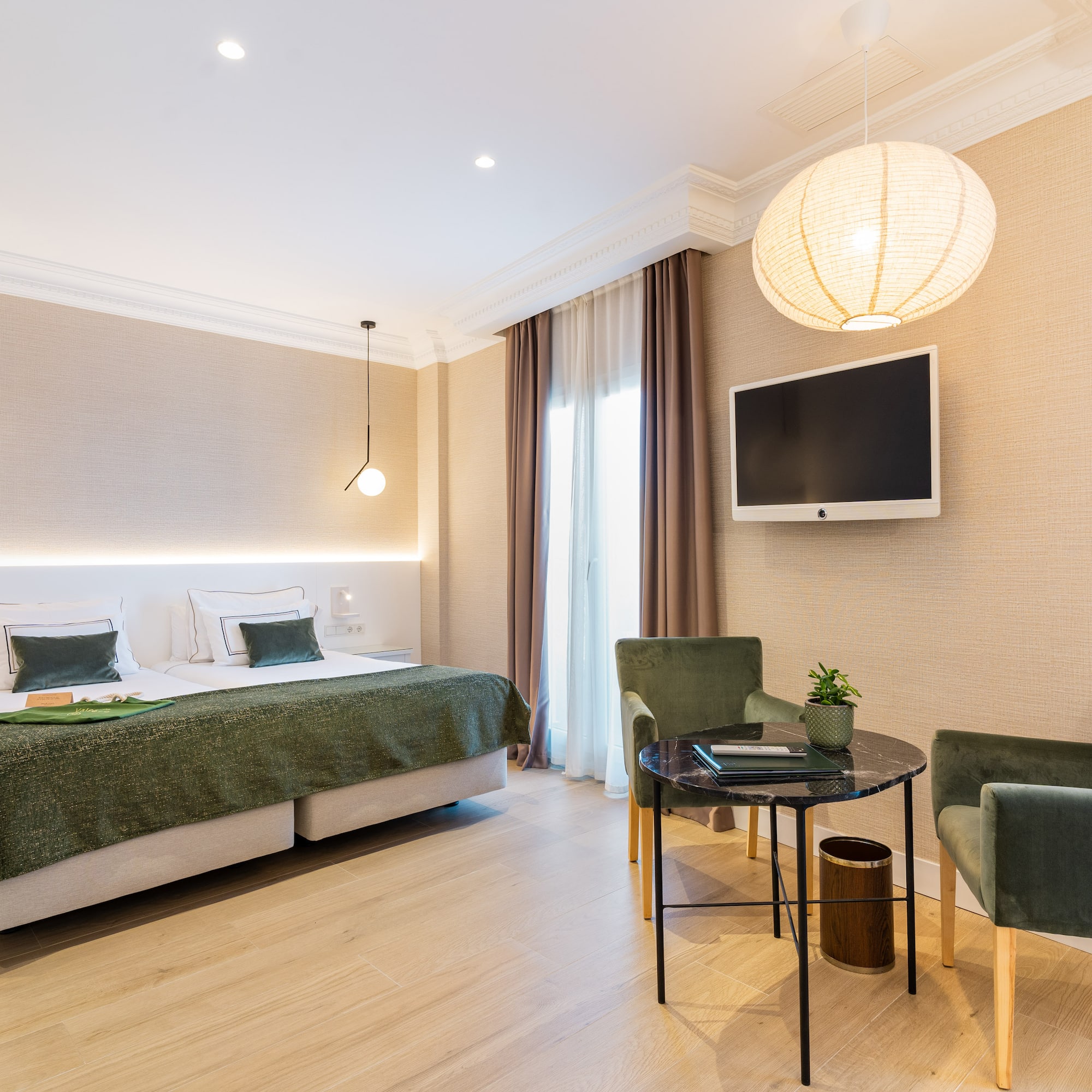 a room with a bed and chairs