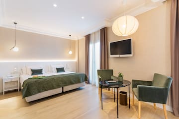 a room with a bed and chairs