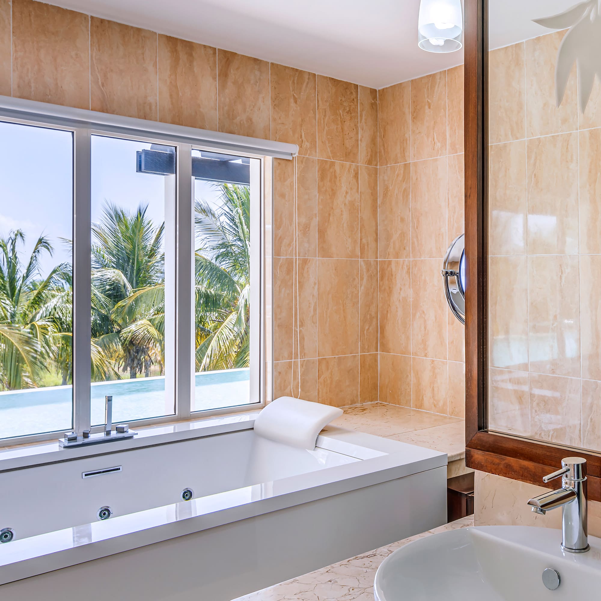 a bathroom with a tub sink and a window