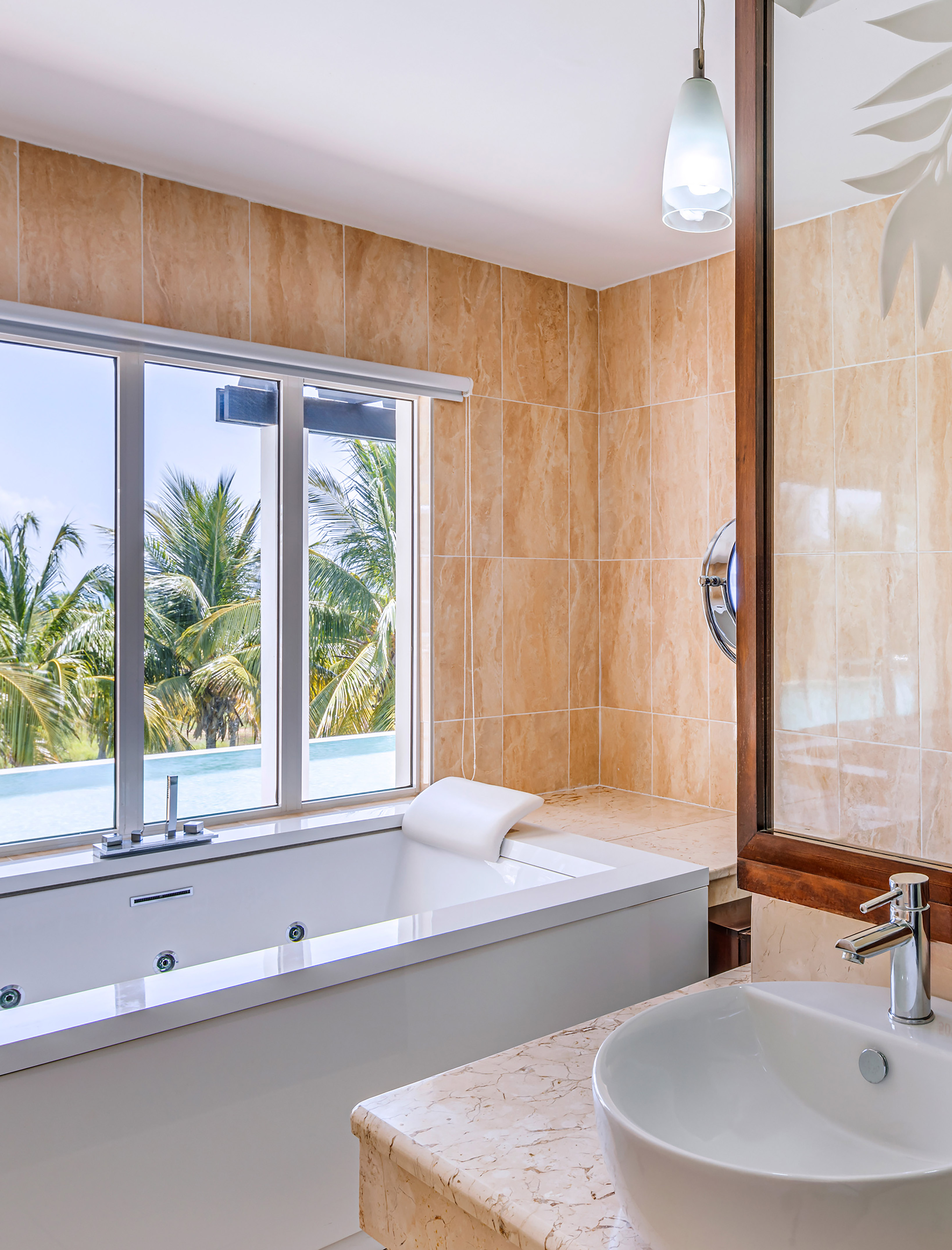 a bathroom with a tub sink and a window