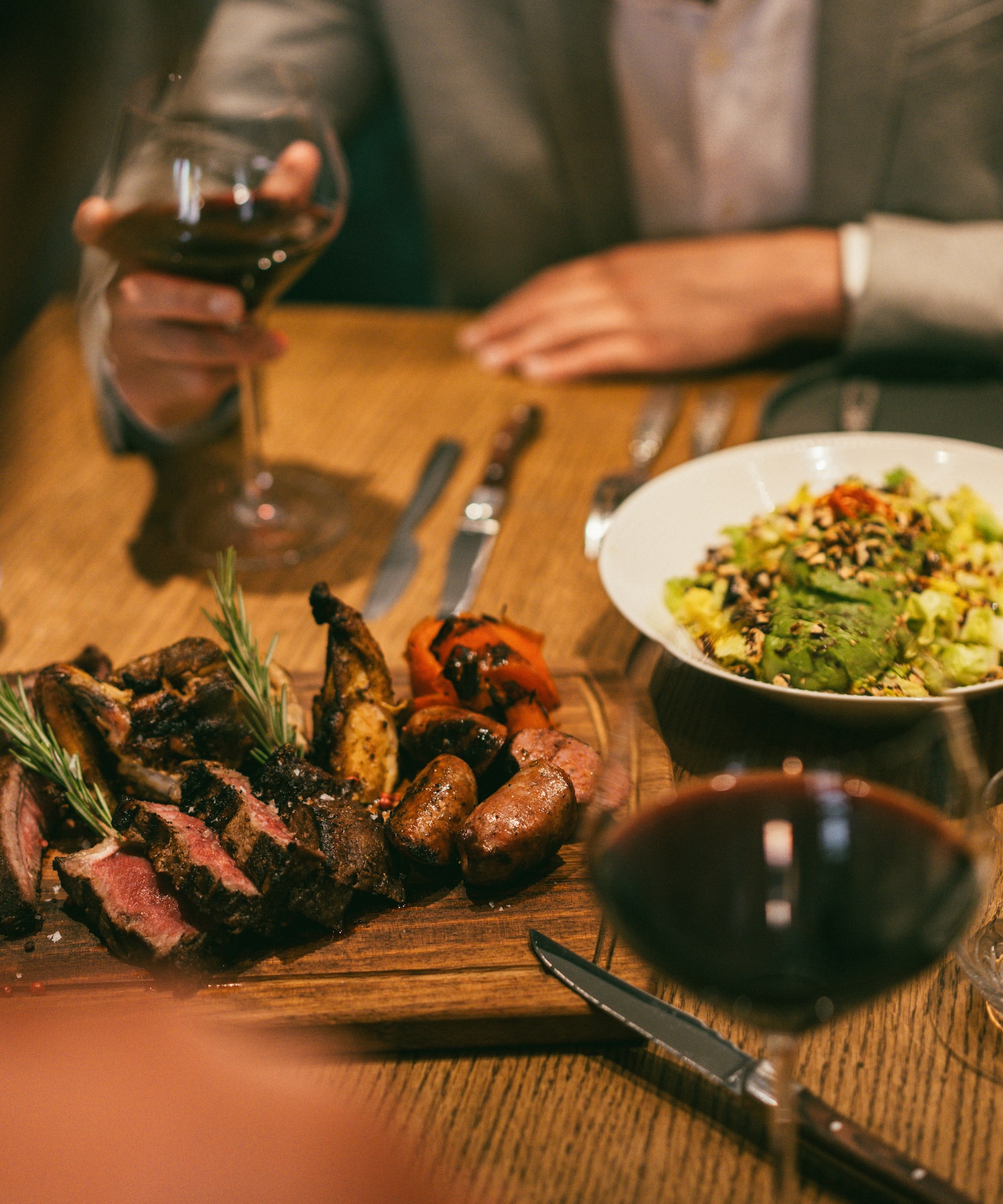 a plate of meat and salad on a table