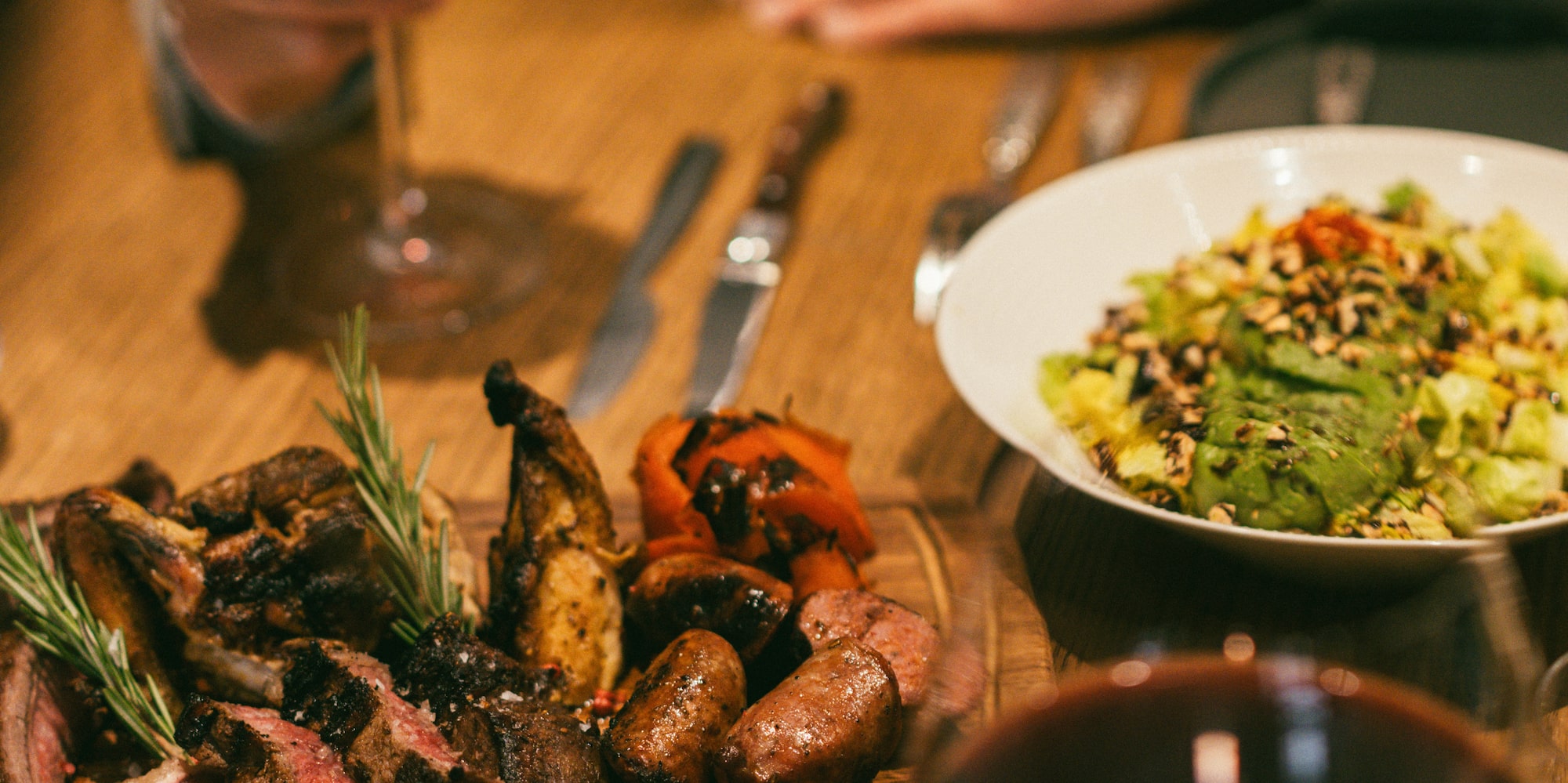 a plate of meat and salad on a table
