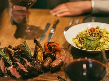 a plate of meat and salad on a table