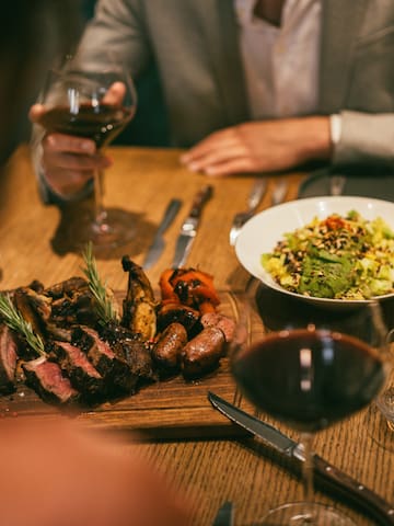 a plate of meat and salad on a table