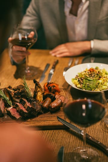 a plate of meat and salad on a table