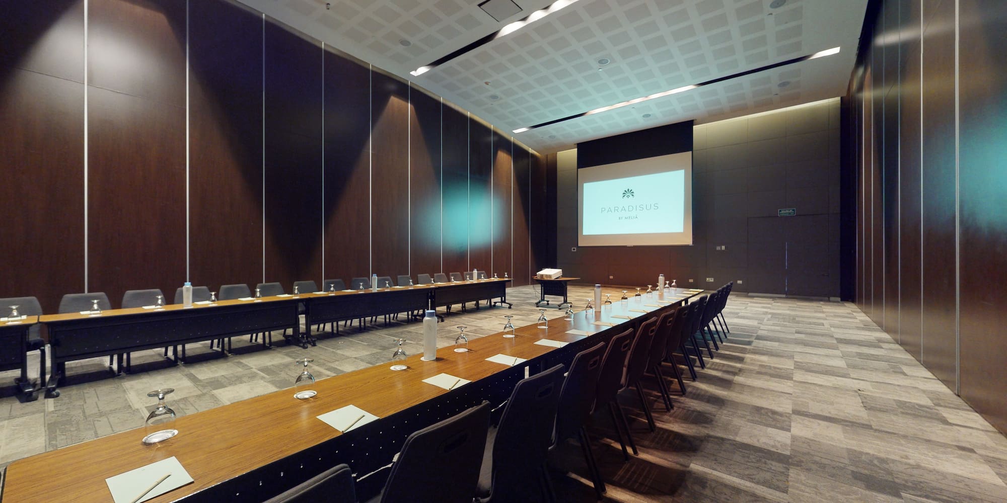 a room with long tables and chairs