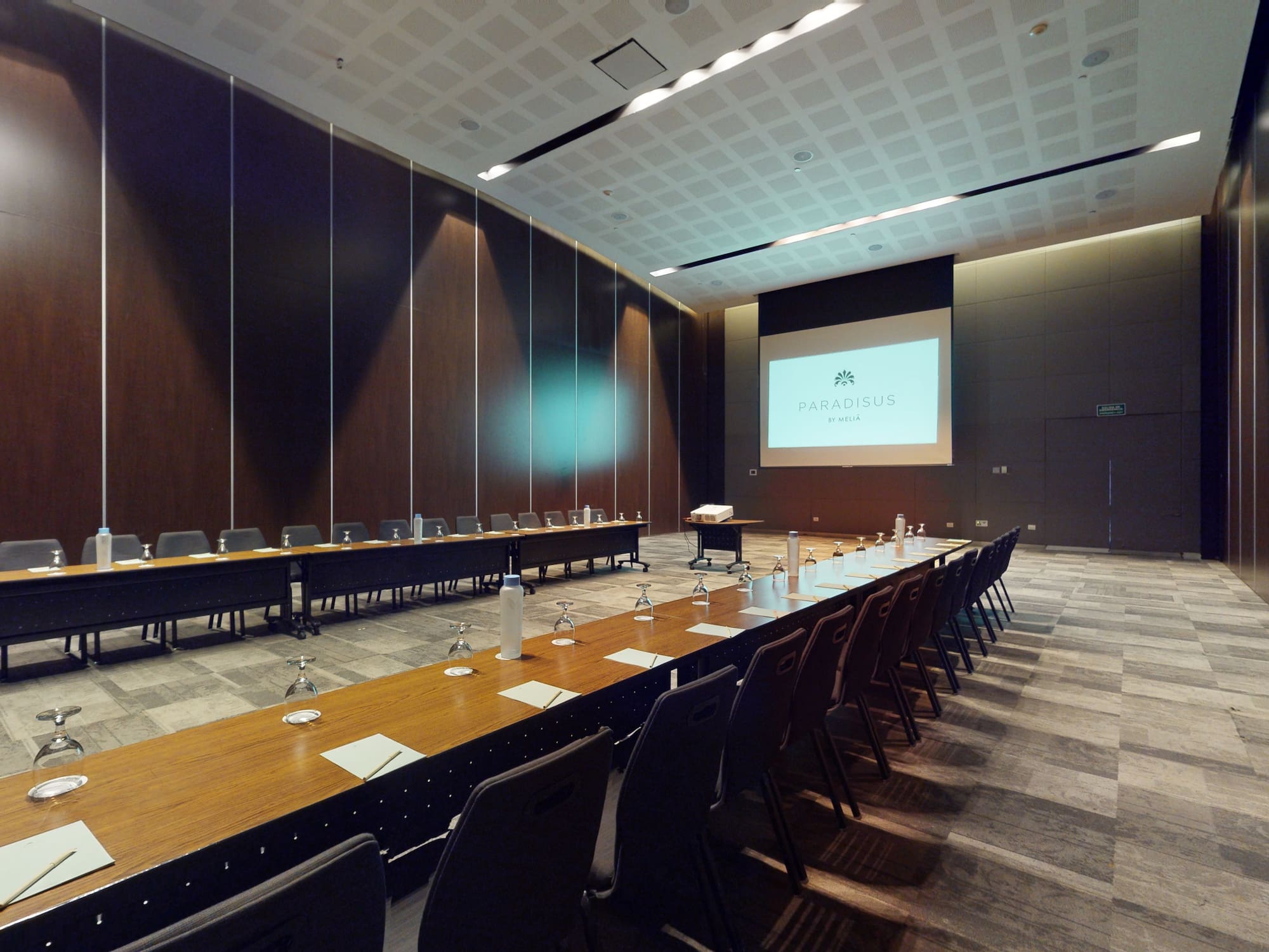 a room with long tables and chairs