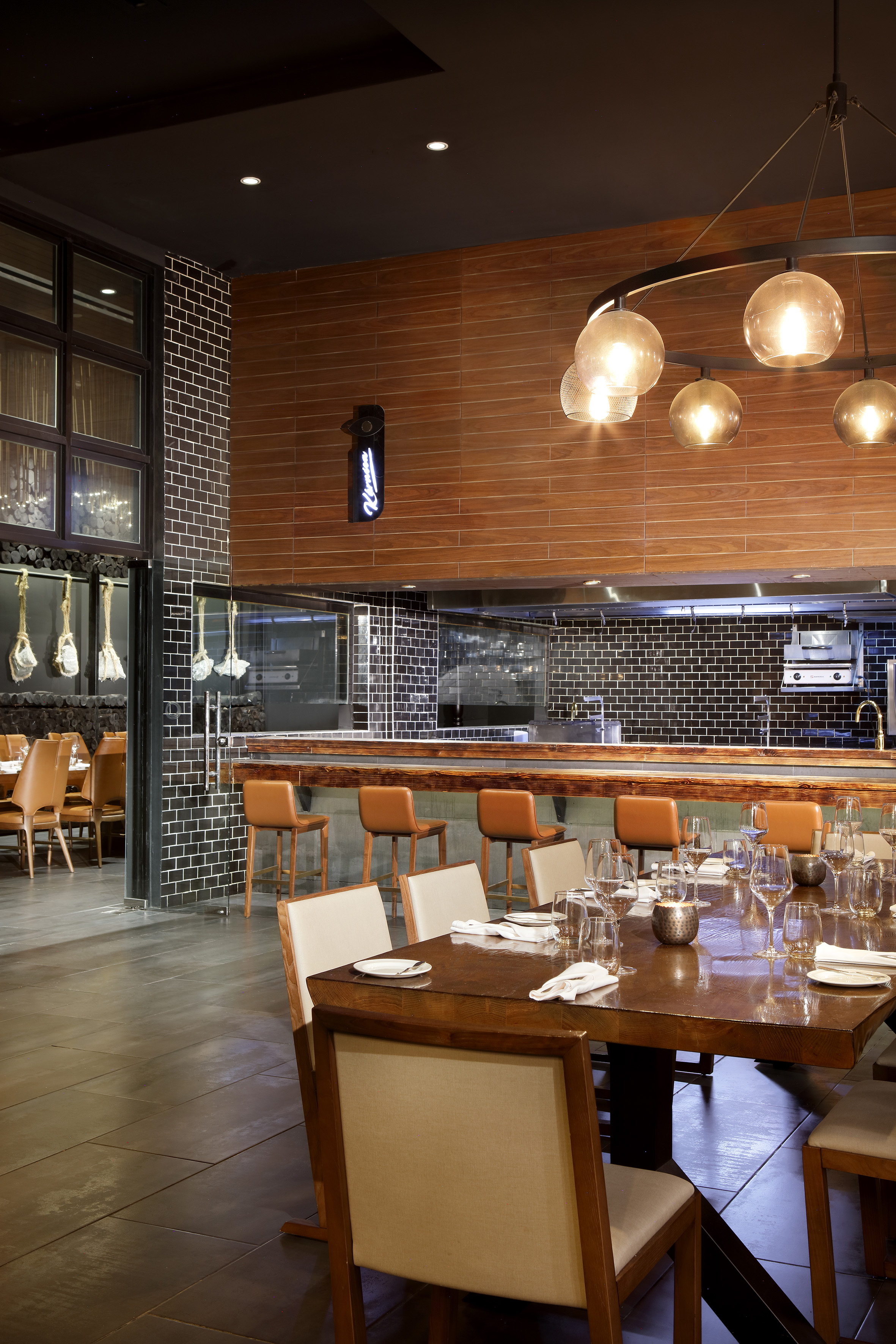 a restaurant with a large table and chairs