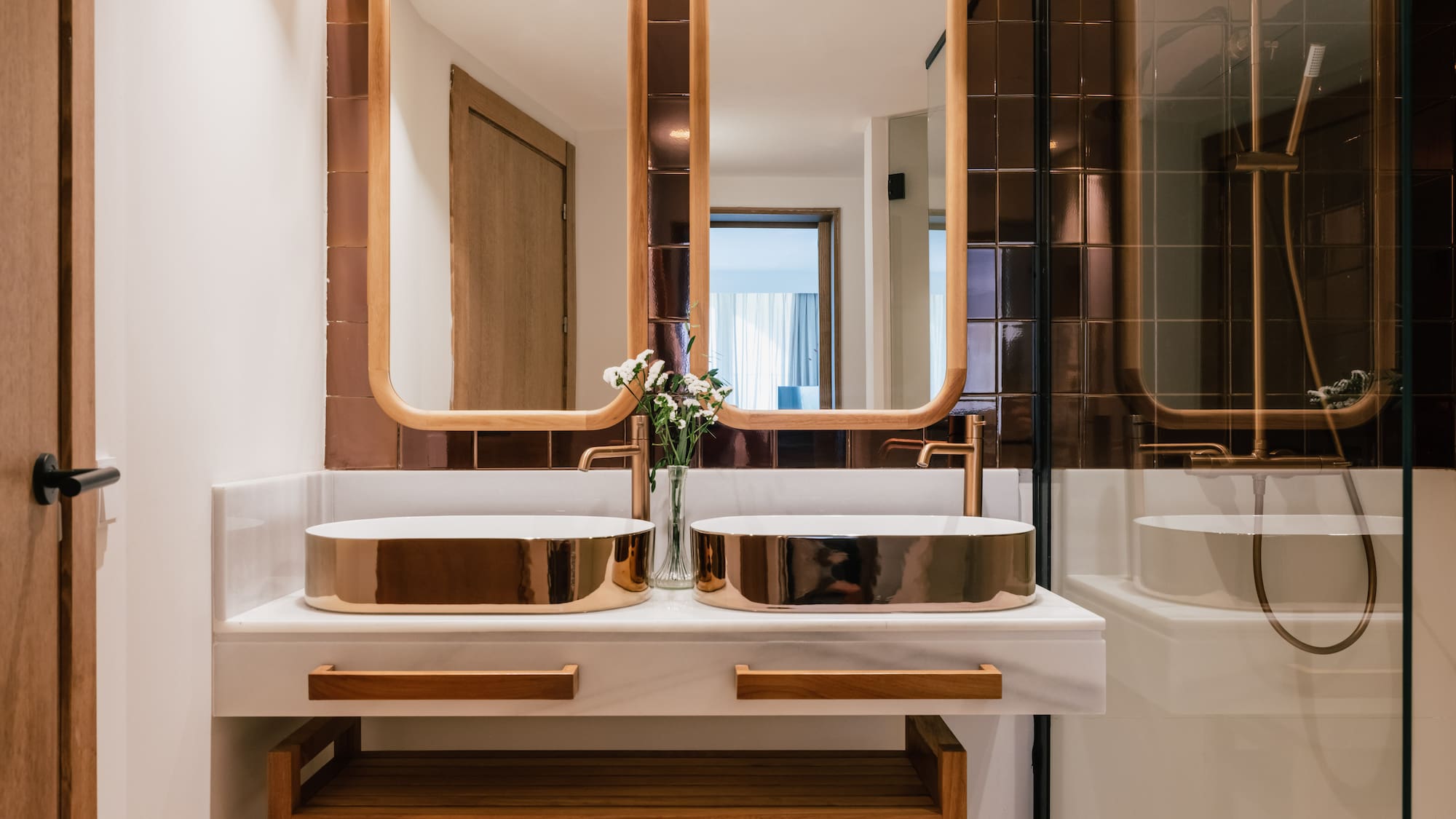 a bathroom with two sinks and a mirror