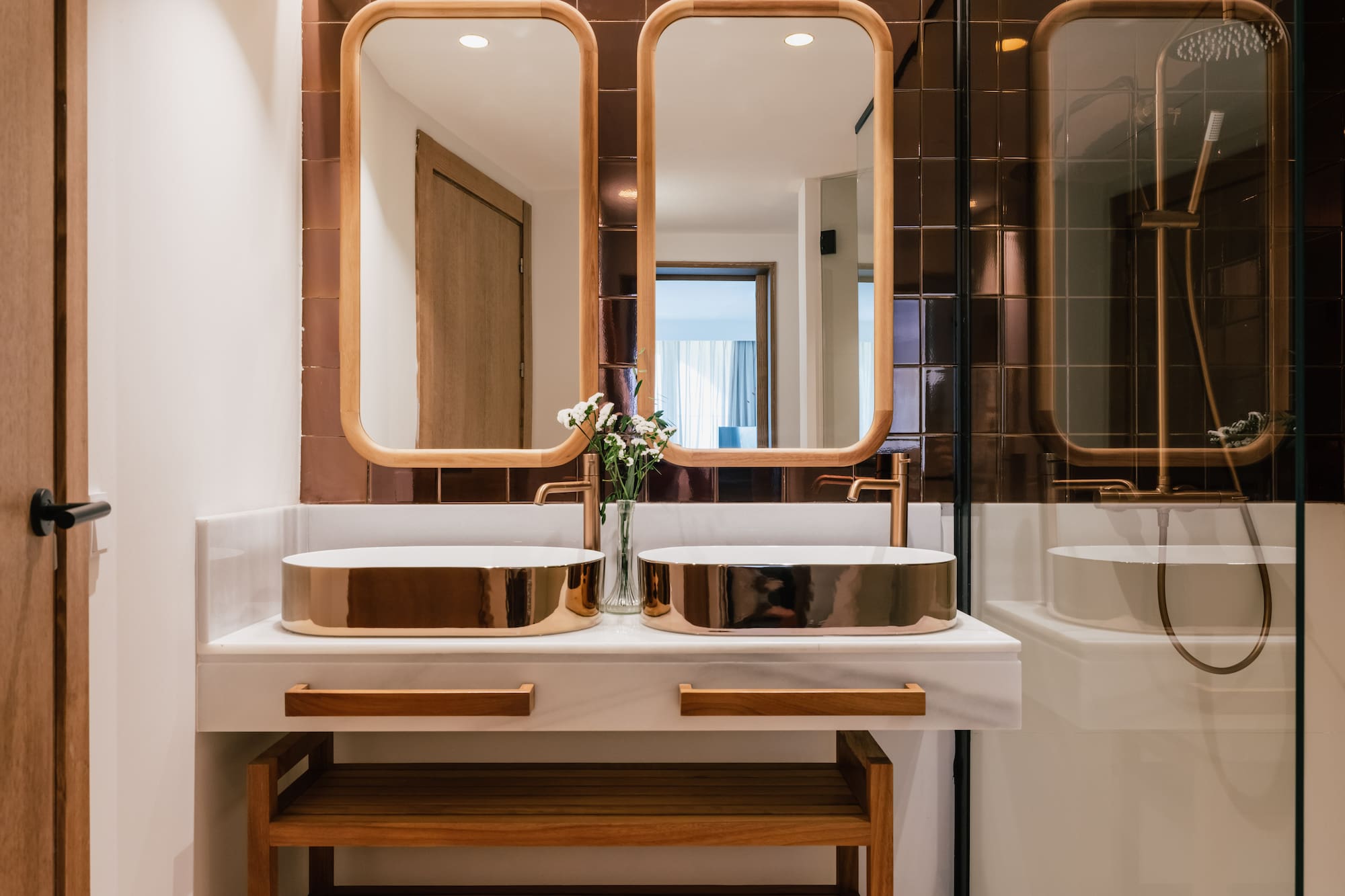 a bathroom with two sinks and a mirror