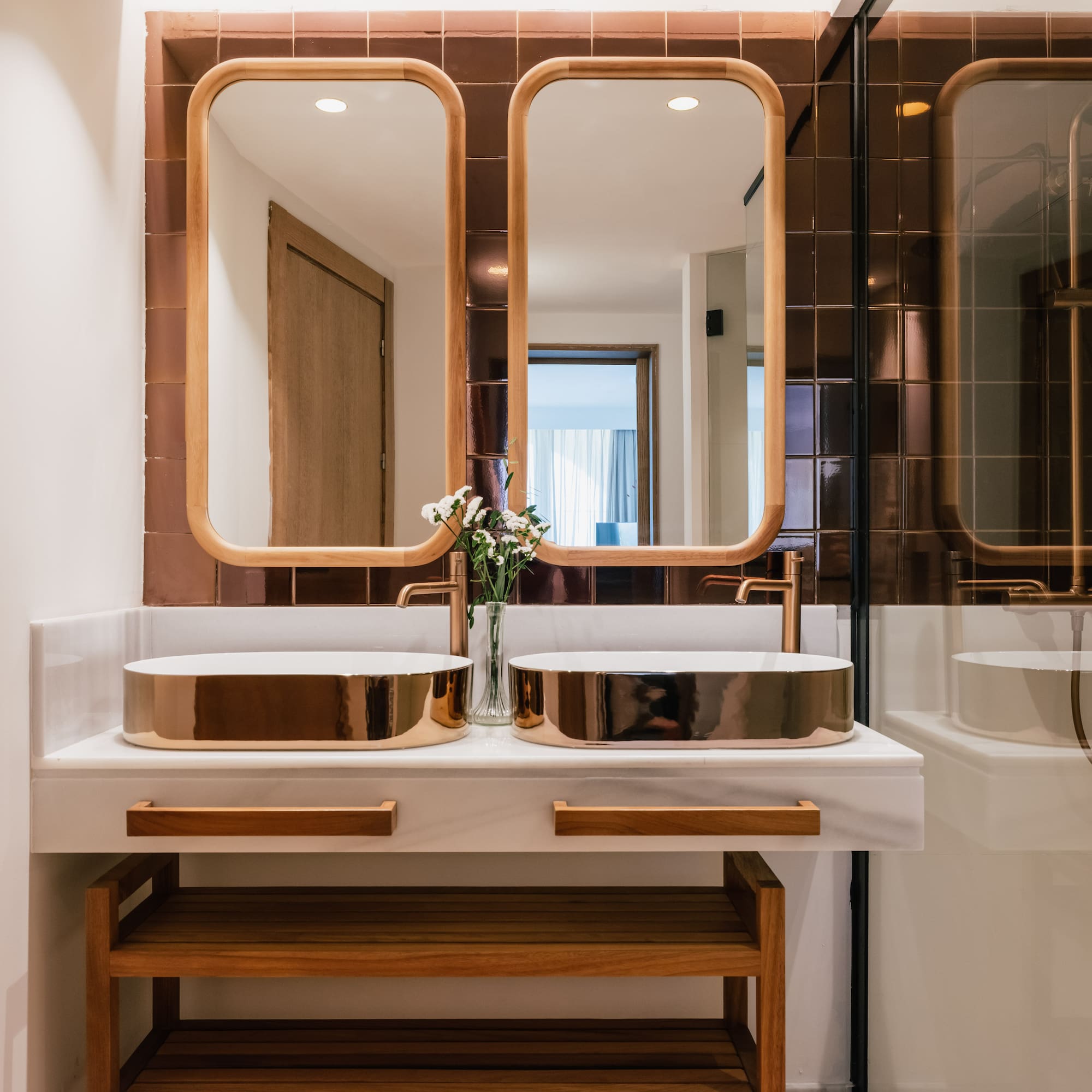a bathroom with two sinks and a mirror