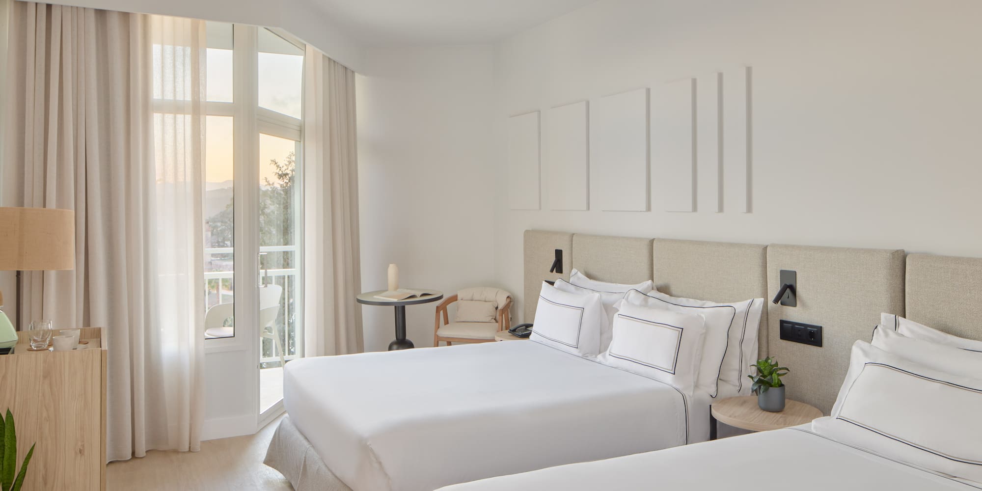 a room with two beds and a balcony