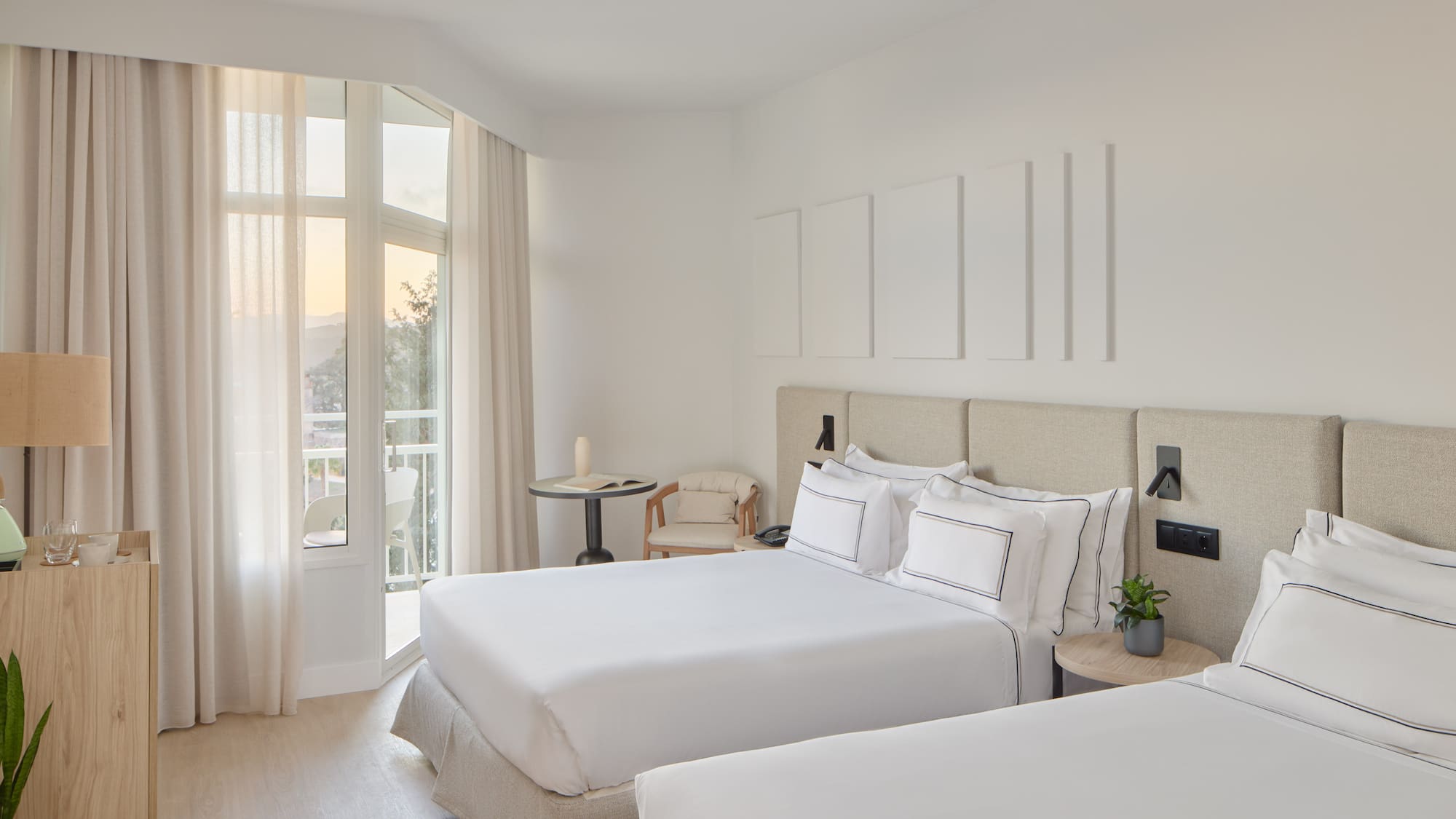 a room with two beds and a balcony