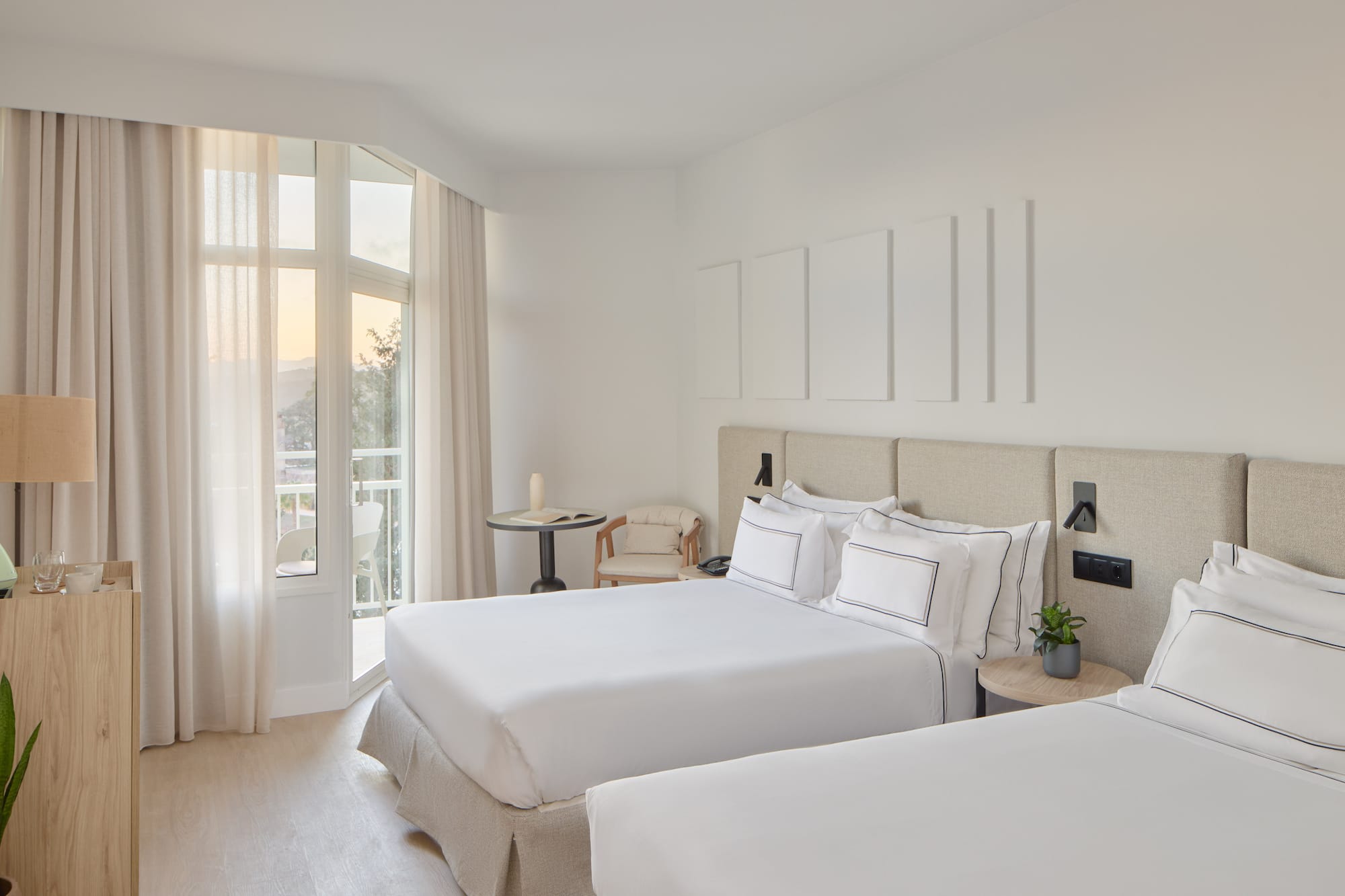 a room with two beds and a balcony